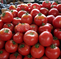 Tomatoes. Fresh organic tomatoes on a market, vegetables background. Salad of tomatoes. Tomato texture. Red tomatoes pattern.  daylight