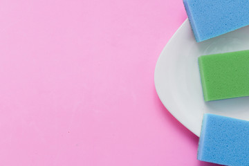 Concept of washing dishes on pastel pink background top view flat lay