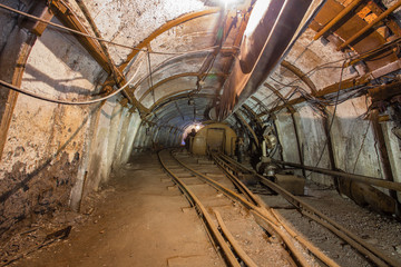 Fototapeta na wymiar Underground coal ore mine shaft tunnel gallery with rotary car tipper
