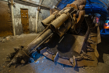 Underground coal ore mine shaft tunnel gallery with 	harvester coal combine miner