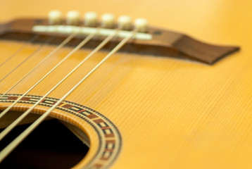 close up details of wooden acoustic guitars string