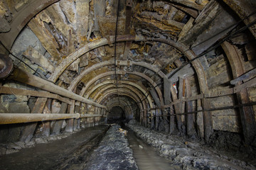 Fototapeta na wymiar Underground old ore gold mine tunnel shaft passage mining technology metal timbering