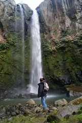Hiker watching the waterfall of Salto do Farinha, Azores islands