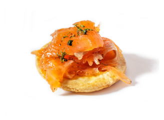 Homemade smoked salmon with dill on traditional Japanese rice cracker (senbei). Isolated on white background.