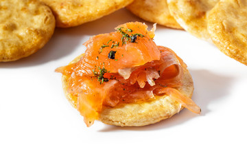 Smoked salmon with dill and traditional Japanese rice crackers (senbei) on white background.