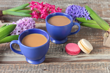 two cups of coffee, hyacinths and macaroons