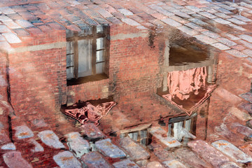 reflection of an old building in a puddle, Vyborg, Russia