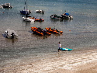Pleasure craft moored in the harbour on a summers day at New Quay, Credigon, Wales, UK