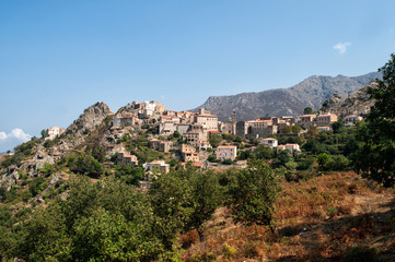 Fototapeta na wymiar A small village in the hills above the sea on the island of Corsica
