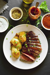 Sliced medium rare roast beef with potato