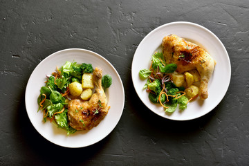 Baked chicken leg with potato and green salad