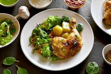 Fried chicken leg with potato and green salad