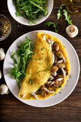  Omelette stuffed with mushrooms, pieces of chicken meat, greens
