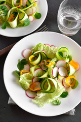 Vegetable salad from zucchini, radish, greens.
