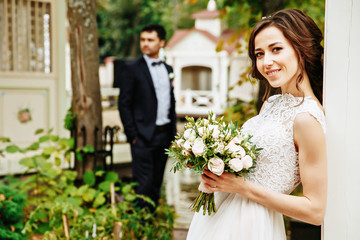 Bridal couple posing outdoor on their wedding day