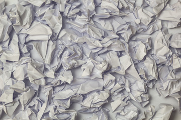 Textured background of white crumpled office leaves of papers.