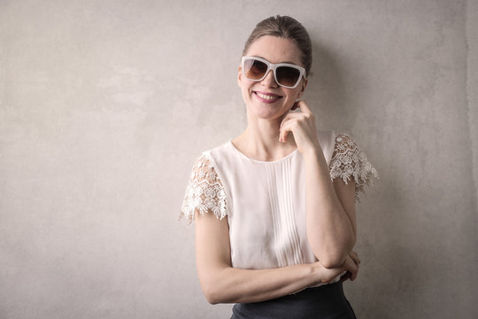 Smiling woman wearing fashionable sunglasses