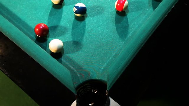 Billiard green ball falls into the hole ,high angle shoot