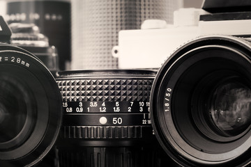 Black and white image of vintage  cameras and lenses