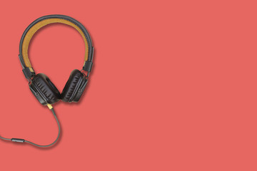 headphones on a red surface background, space for text