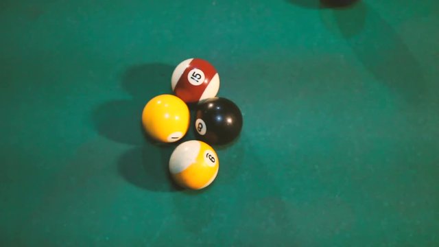 Pool table starting shot close up, four balls left in