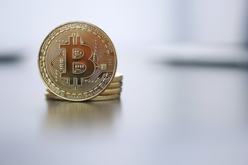 Golden Bitcoin facing the camera in sharp focus, close-up