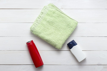 Obraz na płótnie Canvas Composition with plastic bottles and towel of body care and beauty products top view flat lay