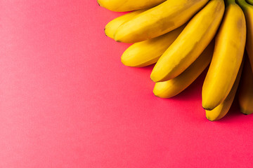 Food background with banana fruit on colored pastel  paper.