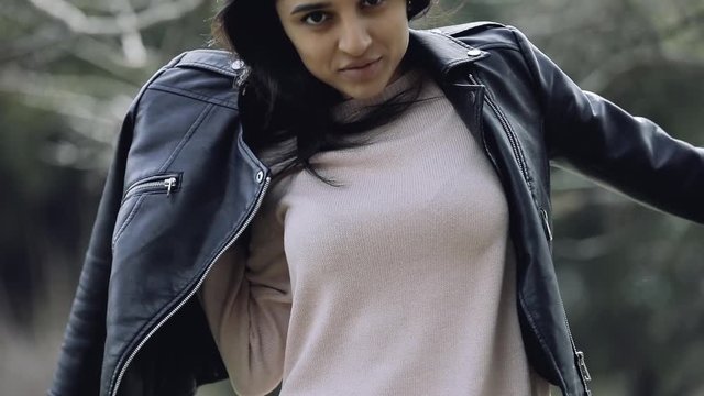 Stylish woman wear leather jacket in park
