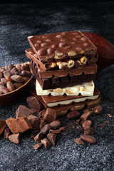 Chocolate bars on dark background with chocolate tower