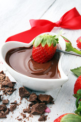 Valentine Chocolate fondue melted with fresh strawberries and dark chocolate and roses