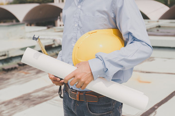 Engineers agree to work together,Architecture at construction site,Consultation for workers,engineer holding white helmet and drawing,Concept foreman,technician man holding safety hat