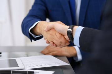 Business people shaking hands, finishing up a meeting. Audit, tax service or agreement concept