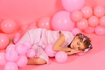 Obraz na płótnie Canvas A portrait of a beautiful little girl sleep in balloons