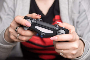 an image of a girl holding a black gaming pad