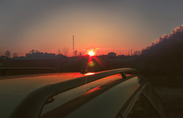 Fototapeta premium Summer. Late evening. The sun almost sat down. The car is dark