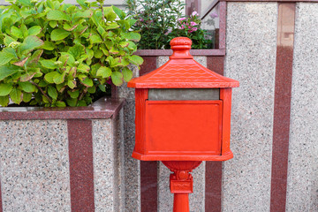 An old home letter box, red painted. Italy