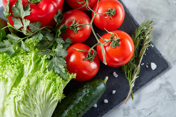 Healthy breakfast with tomatoes, letucce, lime on wooden background, close-up, selective focus, top view.