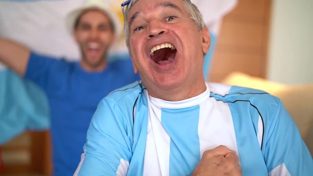 Argentina Father and Son Fans Watching and Celebrating a Soccer Game