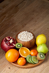 Breakfast still life with oatmeal porridge and fruits, top view, selective focus, shallow depth of field.
