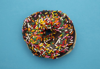 Chocolate Sprinkle Donuts on a Blue Background