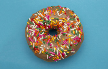 Maple Flavored Sprinkle Donut on a Blue Background