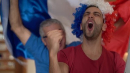 French Father and Son Fans Watching and Celebrating a Soccer Game - Powered by Adobe