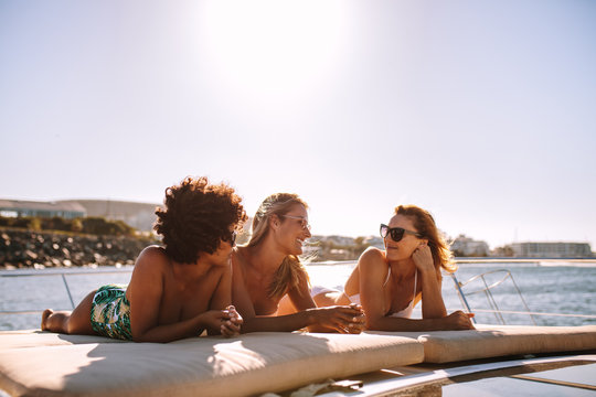 Female friends relaxing on a yacht deck