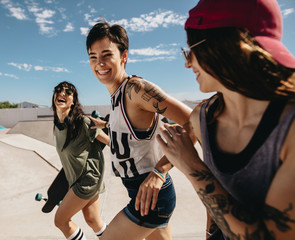 Women friends running outdoors at skate park © Jacob Lund