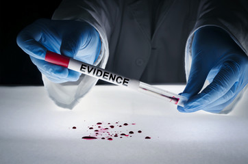 Forensic expert takes a blood sample with a sterile stick collecting evidence. Crime scene...