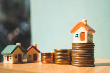 Miniature colorful house on stack coins using as property and financial concept