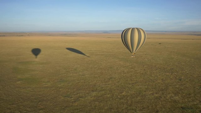 Aerial of a hot air balloon flying over the savannah