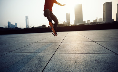 Fototapeta na wymiar Skateboarder skateboarding at sunrise city