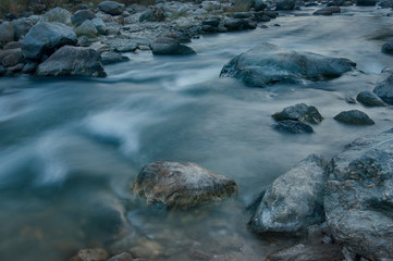 River water flowing through rocks at dawn